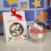 Personalized silver Christmas ornament with the name Alejandra and gift box for 2025.